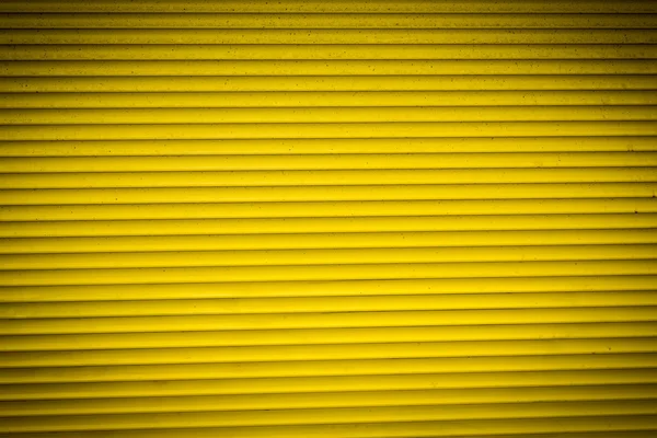 Old yellow rolling shutter for backgrounds — Stock Photo, Image