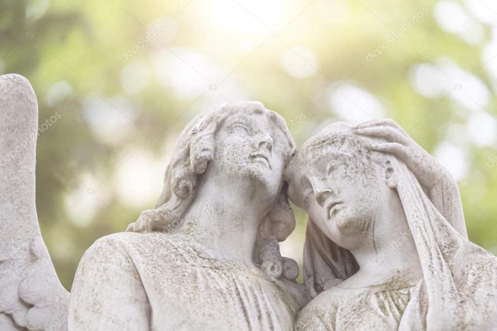 sculpture of two angels in backlit