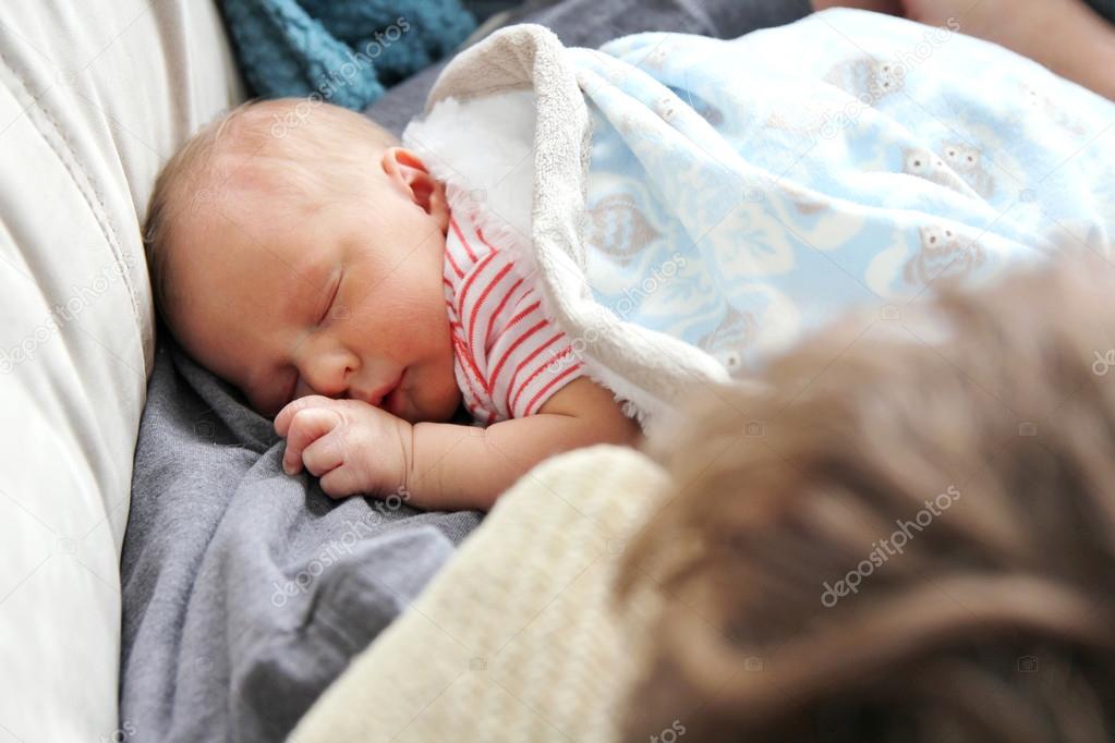 Newborn Baby Girl Sleeping in Father's Arms