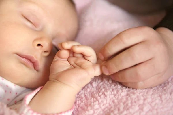 Bebê e irmão amorosamente segurando as mãozinhas — Fotografia de Stock