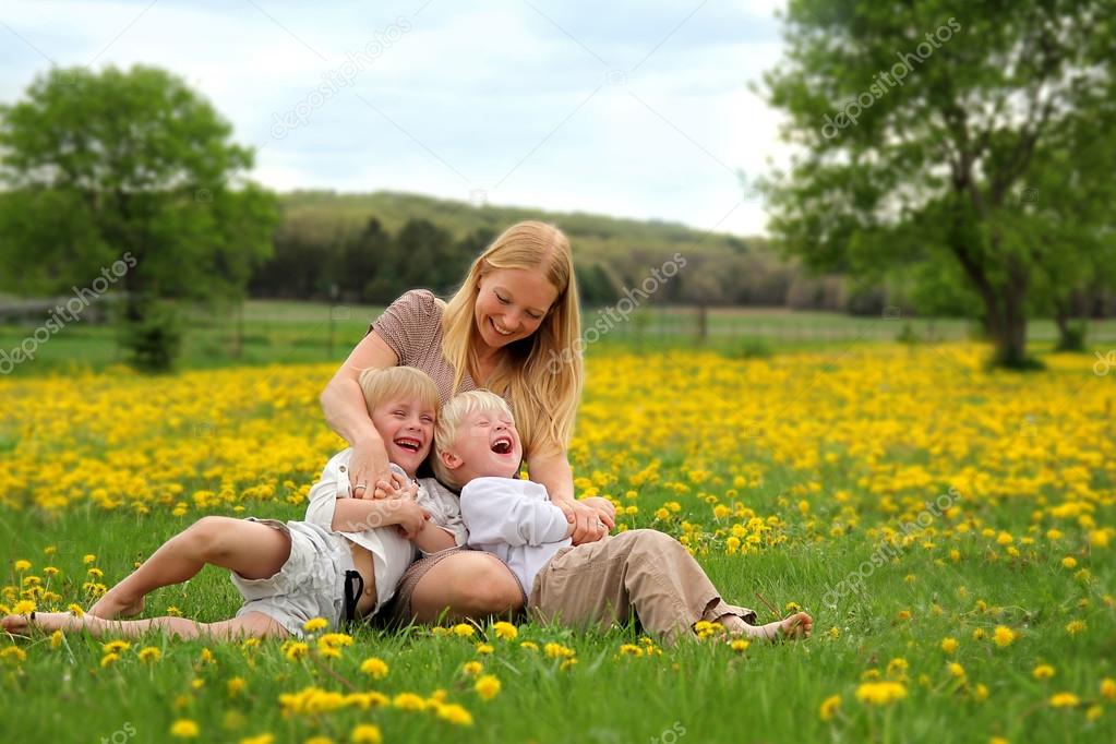 Mother Tickling Young Children
