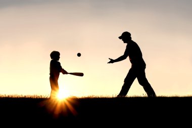 Silhouette of Father and Son Playing Baseball Outside clipart