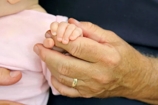 Newborn Baby Girl Holding Grandpa's Hand — Stock Photo, Image