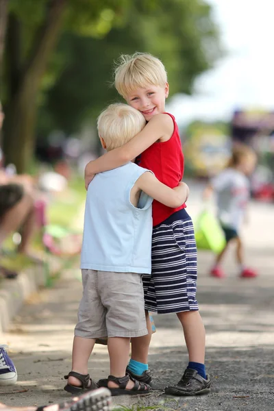 Young Brothers Hug at Parade — Stock Photo, Image