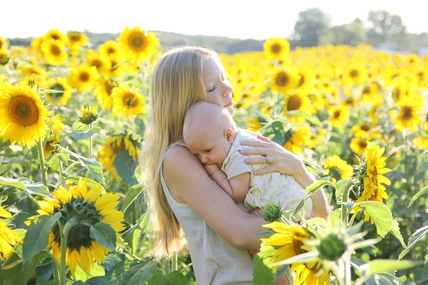 Mother Holding Baby Daughter in Flower Meadow — Stock Photo, Image