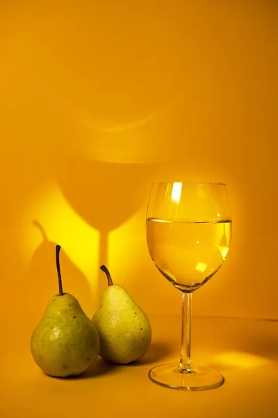 Classic still life with pears, white wine on a bright yellow background. advertising of wineries and restaurants. photo for the author\'s culinary blog. saumillier. wine tasting.