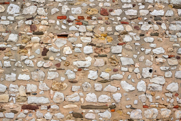 Closeup image of the textures and colours of a stone wall