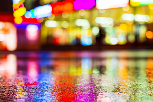 Rainy night. Parking mall. Reflections of shop windows