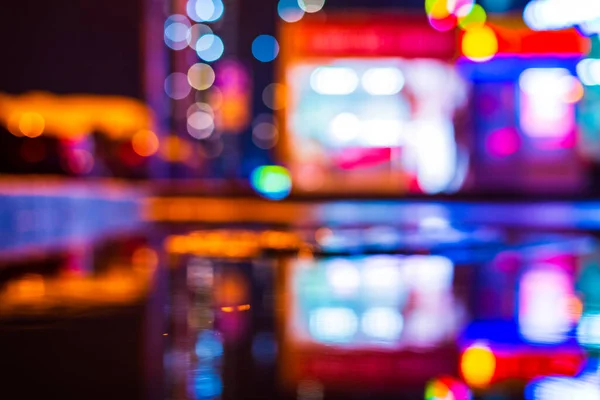 Rainy night. Parking mall. Reflections of shop windows