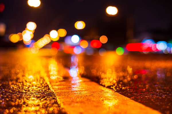 Rainy night in the city. Headlights driving cars. 