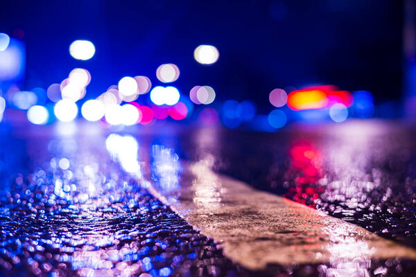 Rainy night in the city. Headlights driving cars. 