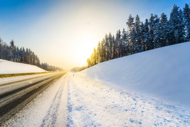 Açık bir kış sabahında gün doğumu, karda boş otoyollar. 