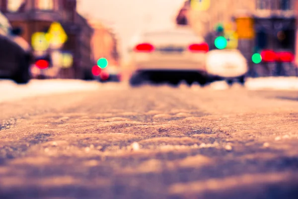 Snowy winter in the big city, on the snowy street going cars