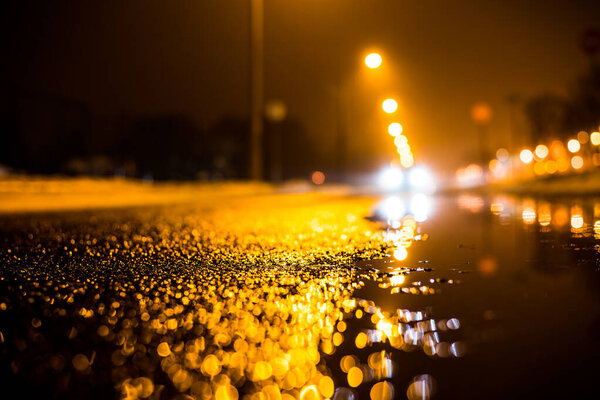 Foggy night in the big city, the empty street lighting lanterns. 