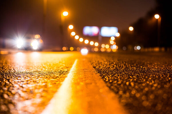 Foggy night in the big city, lights of approaching cars.