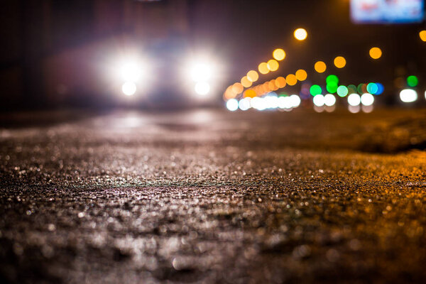 Rainy night in the parking shopping mall, rows of parked cars.