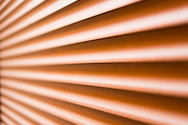 Brown metal shutters at the windows. Close up view