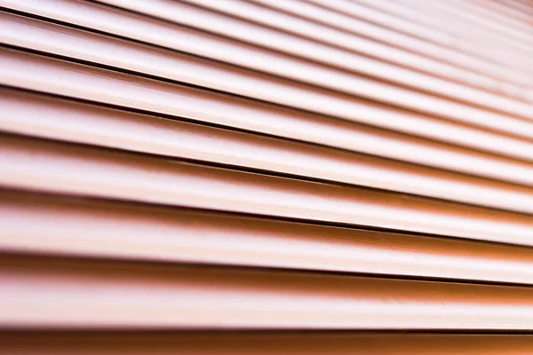 Brown metal shutters at the windows. Close up view