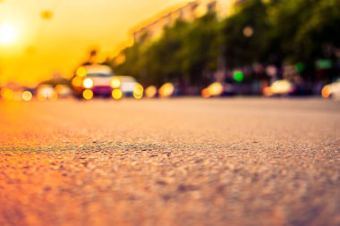 Şehirde gün batımı, otoyolda yaklaşan minibüs. Kapat.