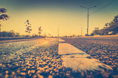 Sunset after rain, sun reflecting in wet road surface