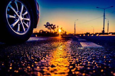 Sunset after rain, sun reflecting in wet road surface