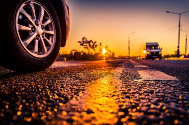 Sunset after rain, sun reflecting in wet road surface