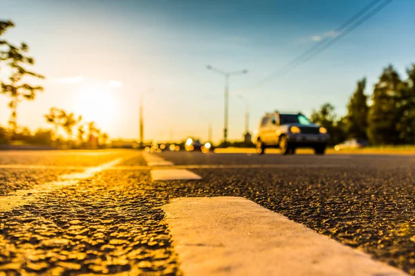 Sunset in the country, the stream of cars passing by on the high