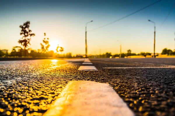 Sunset after rain, sun reflecting in wet road surface