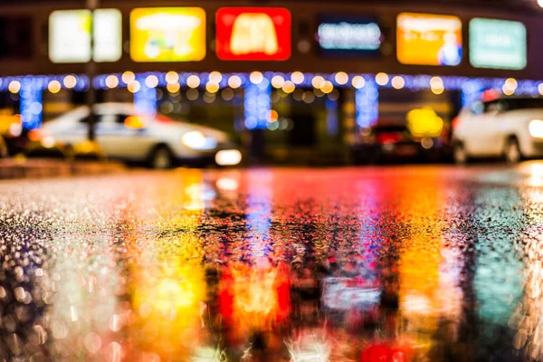 Rainy night in the big city, the cars passing on the highway.