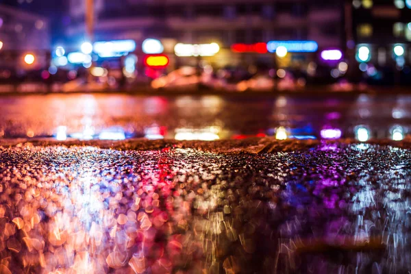 Rainy night in the big city, the cars passing on the highway.