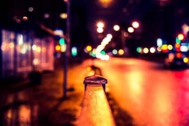 Büyük şehirde karanlık bir gece, otobüs durağı ve arabayla yol.. 