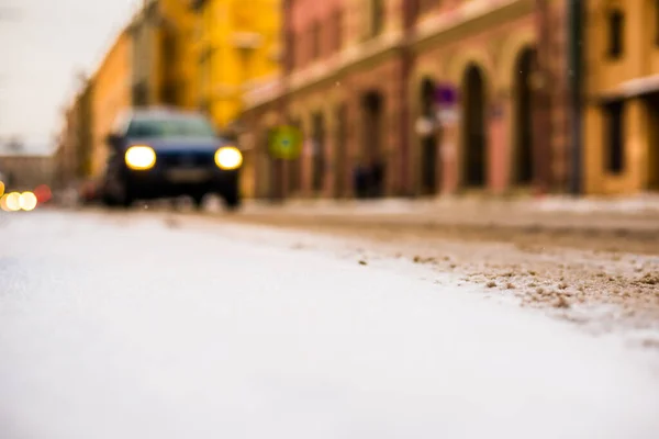 Snowy winter in the big city, on the snowy street going cars