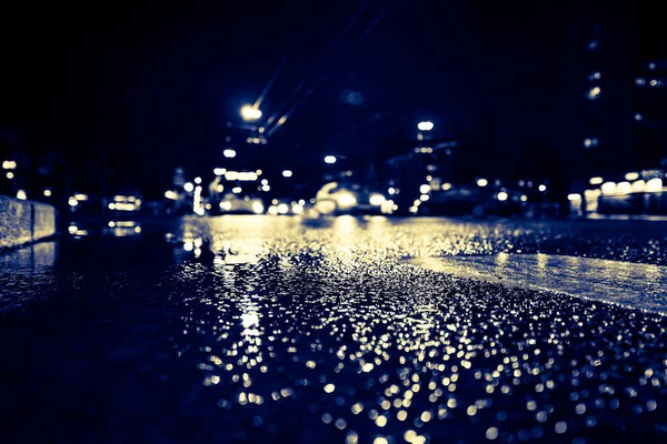 Rainy night in the big city, cars traveling on wet highway.