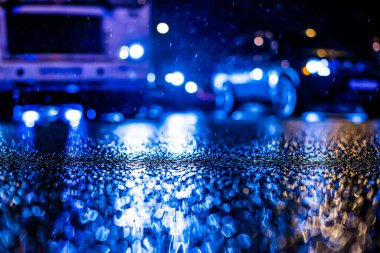 Büyük şehirde yağmurlu bir gece, yoğun bir caddede akşam trafiği sıkışık.