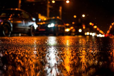 Büyük şehirde yağmurlu bir gece, yoğun bir caddede yoğun trafik.
