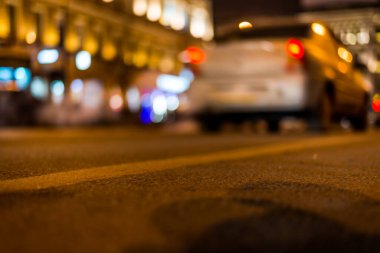 Büyük şehrin gece ışıkları, asfalt seviyesinden manzarayı kapatın. 