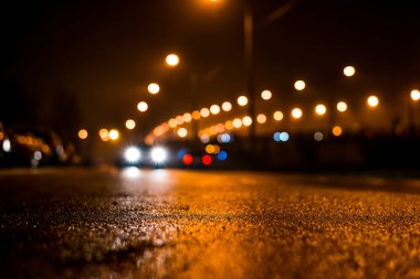 Şehir gece lambaları, trafik ışıkları ve hareket halindeki arabalar.