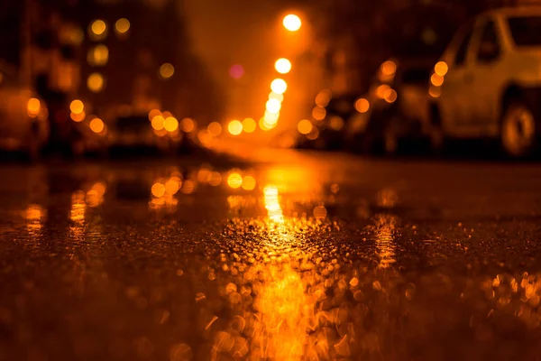 Rainy and foggy night in the city, the street with cars