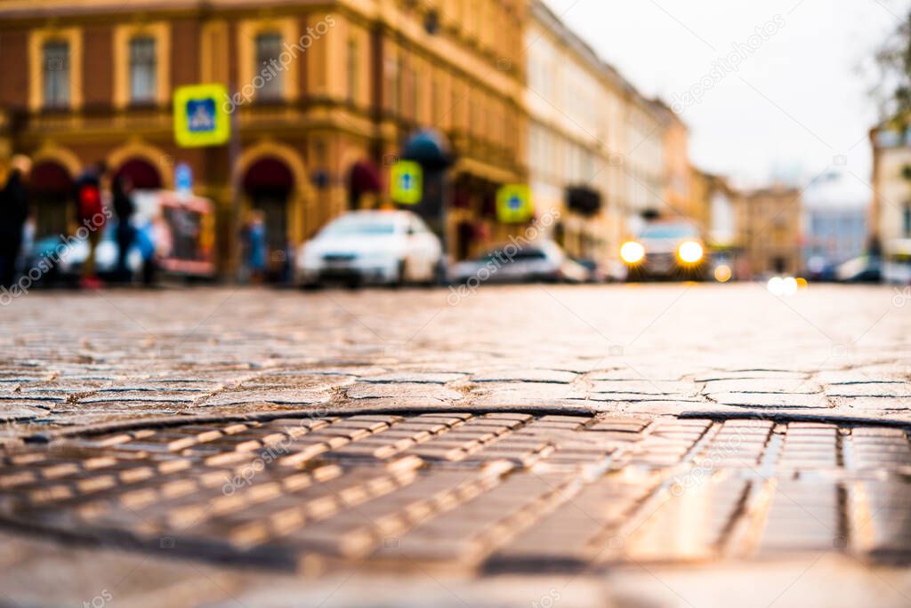 City central square after rain, car traveling on the street. Vie