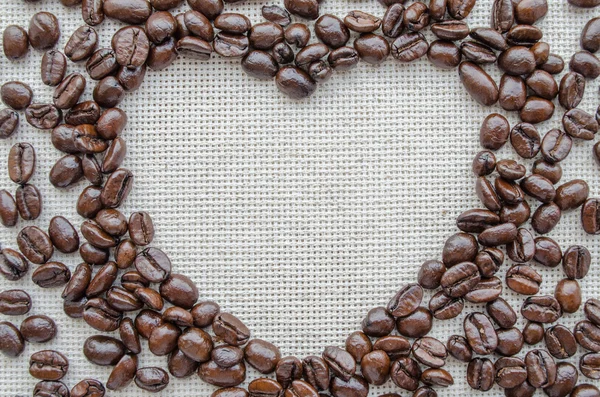 Heart made from coffee beans on textured sack — Stock Photo, Image