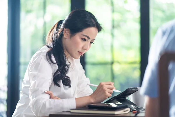 Asian business woman talk to colleagues about plan in video conference. Group of multiethnic business people use computer for virtual online meeting in video call conference. Smart working from home.