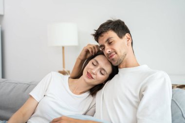 Kafkasyalı genç çift boş zamanlarını birlikte oturma odasında geçiriyorlar. Çekici yeni evli erkek ve kadın sabahları evdeki kanepede oturup uzanıyorlar. Evde etkinlik ilişkisi.