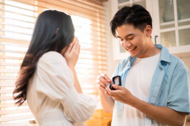 Asyalı romantik bir adam kız arkadaşına sürpriz evlilik teklifi yapıyor. Çekici genç bir erkek ve güzel mutlu bir kadına evlenme teklif ediyor. Alyansı evde, mutfakta sürpriz bir nişanın keyfini çıkarıyor..