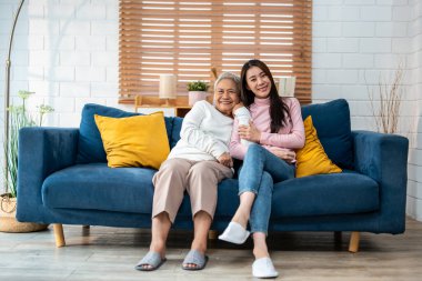 Asyalı güzel bir ailenin portresi, kızı evde yaşlı bir anneyle oturuyor. Çekici torun, yaşlı anneyi ziyaret ediyor. Oturma odasında vakit geçirip kameraya bakıyor..