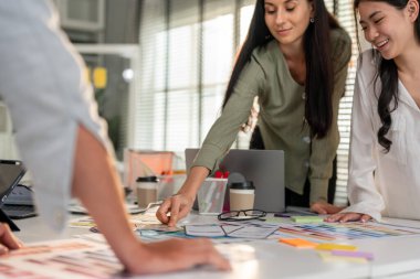 Ofis işyerinde çalışan bir grup genç iş kadınını kapatın. Çekici bir çalışanın beyin fırtınası ve ekip olarak buluşması, planlama ve tartışmalar. Modern meslektaş konsepti.