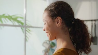 Pencereden bakarken gülümseyen kadın