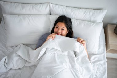 Asyalı iri kadın portresi sabah mutlulukla uyanıyor. Çekici, genç, kıvrımlı bir kadın mutlu ve rahat hisseder. Sonra yatak odasında yataktan kalktıktan sonra kameraya bakar..