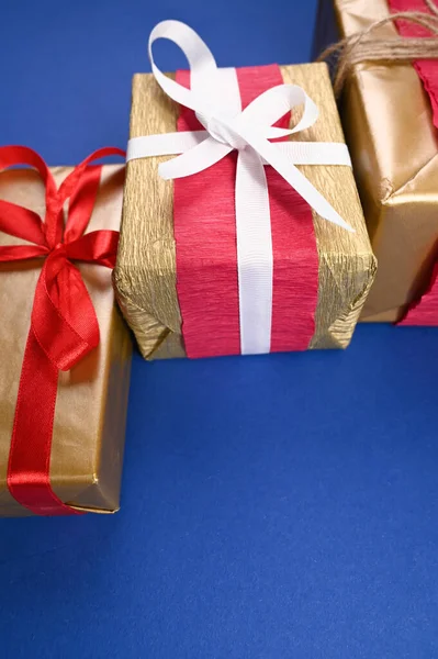 Three gift packages on a blue background, top view. High quality photo