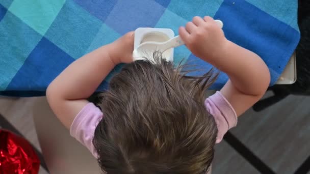 Baby boy eating a spoonful of yogurt. Light breakfast of the child — Stock Video