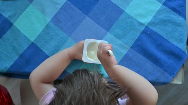 Baby boy eating a spoonful of yogurt. Light breakfast of the child — Stock Video